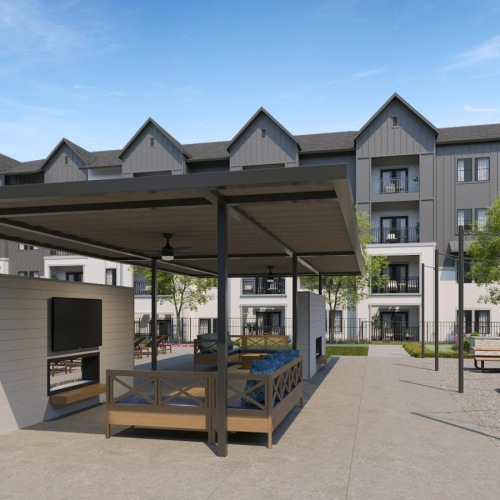 an outdoor lounge area with a tv, couch, tables and chairs